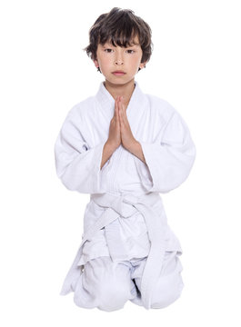 young asian boy isolated on white in judo clothing doing martial arts