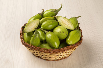 Some green african eggplants over a white background