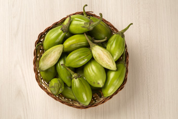 Some green african eggplants over a white background