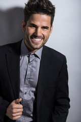 handsome young man in suit on grey background. Business man