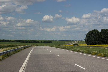 Asphalt road over blue sky background.