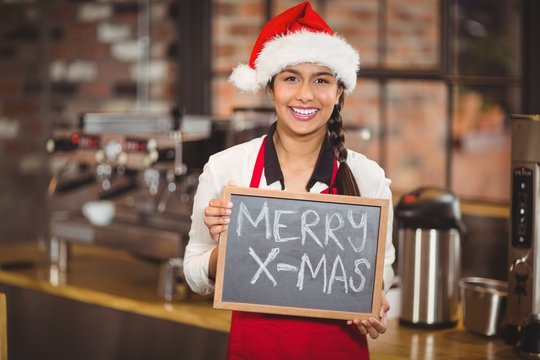 Pretty waitress with a chalkboard merry x-mas - Powered by Adobe