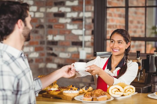 Smiling waitress serving a client