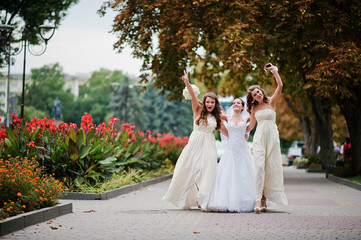 Stylish bridesmaids have fun with bride