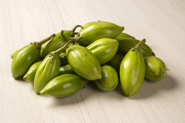 Some green african eggplants over a white background