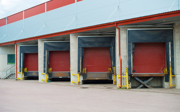 Warehouse with four red sliding gates.