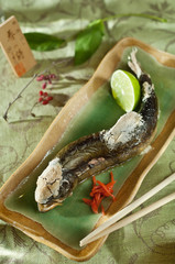 Trout baked on the grill, served with green salt, thai food