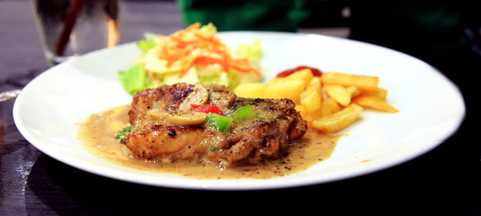 Grilled steaks, baked potatoes and vegetables