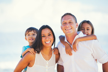Happy Mixed Race Family Having Fun Outdoors - 87506289