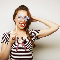 Playful young women holding a party glasses. 