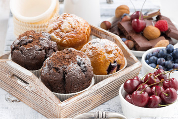 Fototapeta na wymiar assortment of fresh delicious muffins and fresh berries