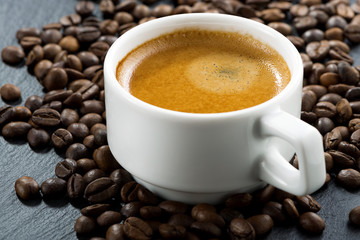 espresso on coffee beans background, close-up, selective focus