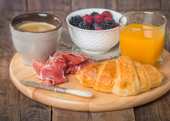 Breakfast with orange juice, fresh croissant