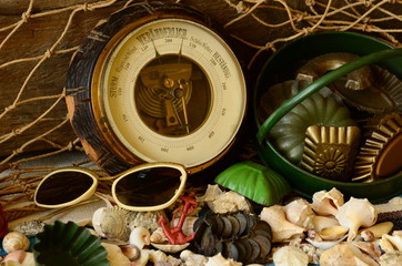 Vintage barometer, beam trawl, sunglasses and retro beach toys. Vintage summer