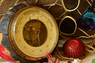 Vintage barometer, beam trawl, sunglasses and retro beach toys. Vintage summer
