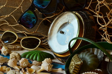Vintage barometer, beam trawl, sunglasses and retro beach toys. Vintage summer