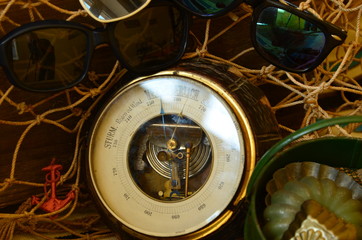 Vintage barometer, beam trawl, sunglasses and retro beach toys. Vintage summer