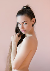 Naklejka premium Portrait of a beautiful young woman on a beige background. Selective soft focus on eyes.