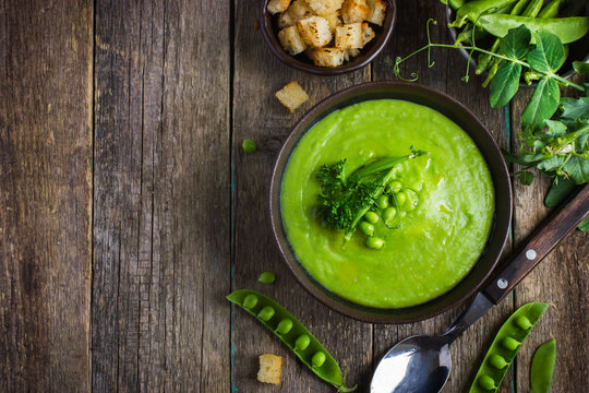 green peas soup on rustic background
