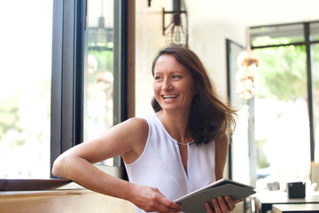 Smiling woman with tablet