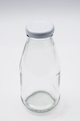 Empty colorless glass bottle on White Background