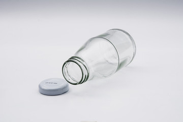 Empty colorless glass bottle on White Background