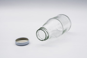 Empty colorless glass bottle on White Background