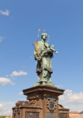 Fototapeta na wymiar Statue of St. John of Nepomuk on Charles Bridge in Prague