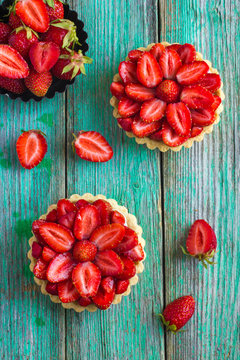 Tart with fresh strawberry on wooden background