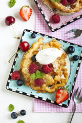 Funnel cakes with fresh berries and whipped cream