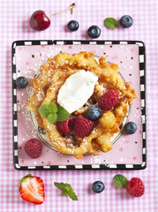 Funnel cakes with fresh berries and whipped cream