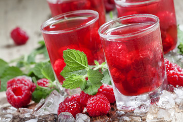 Cold Raspberry drink with mint and ice, selective focus