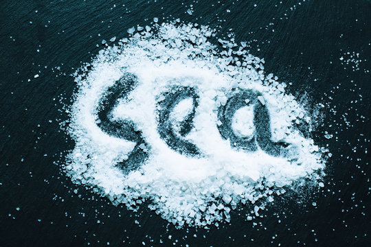 Sea salt with the inscription "sea" on a dark background, select