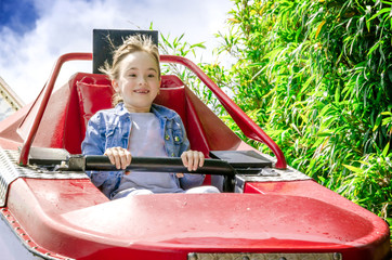 Girl riding on a roller coaster.