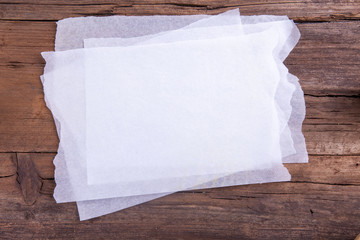 Cooking paper four sheets shot from above on a wooden background