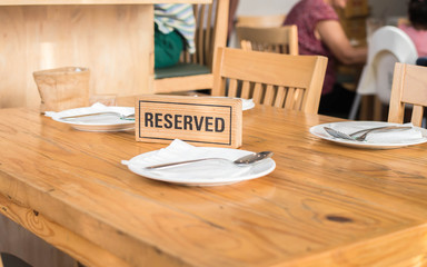 Reserved sign on a table in restaurant