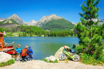 Family on bank of amazing mountain lake