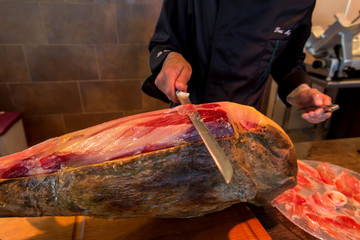 jamon iberico, spanish ham, with man