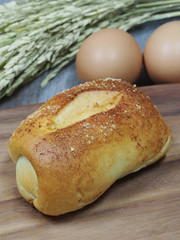 fresh bread and wheat on the wooden