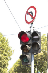 Traffic light and prohibited turn sign.