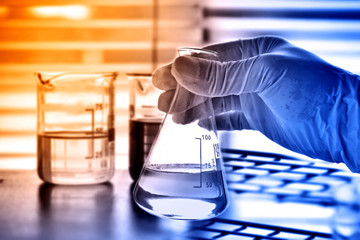 flask in scientist hand, laboratory concept 