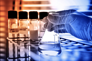 flask in scientist hand, laboratory concept 