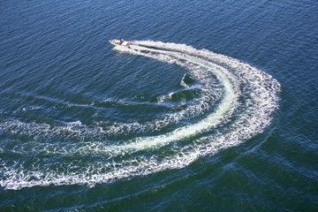 Powerboat and his trace on the blue sea