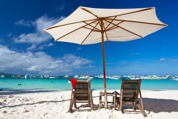 Sun umbrella with Santa Claus Hat on chairs