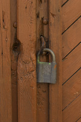 Close up of an wooden door with a lock