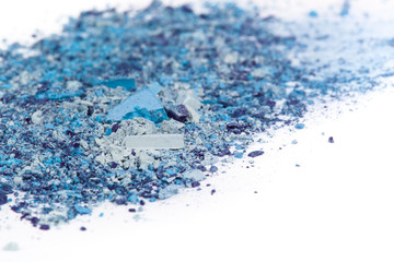 Crushed eyeshadows on white background