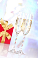 Pair glasses of champagne and present box