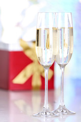 Pair glasses of champagne and present box