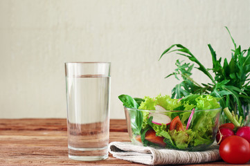 Vegetable salad with a glass of pure water