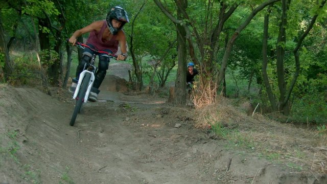 two bikers go downhill 
